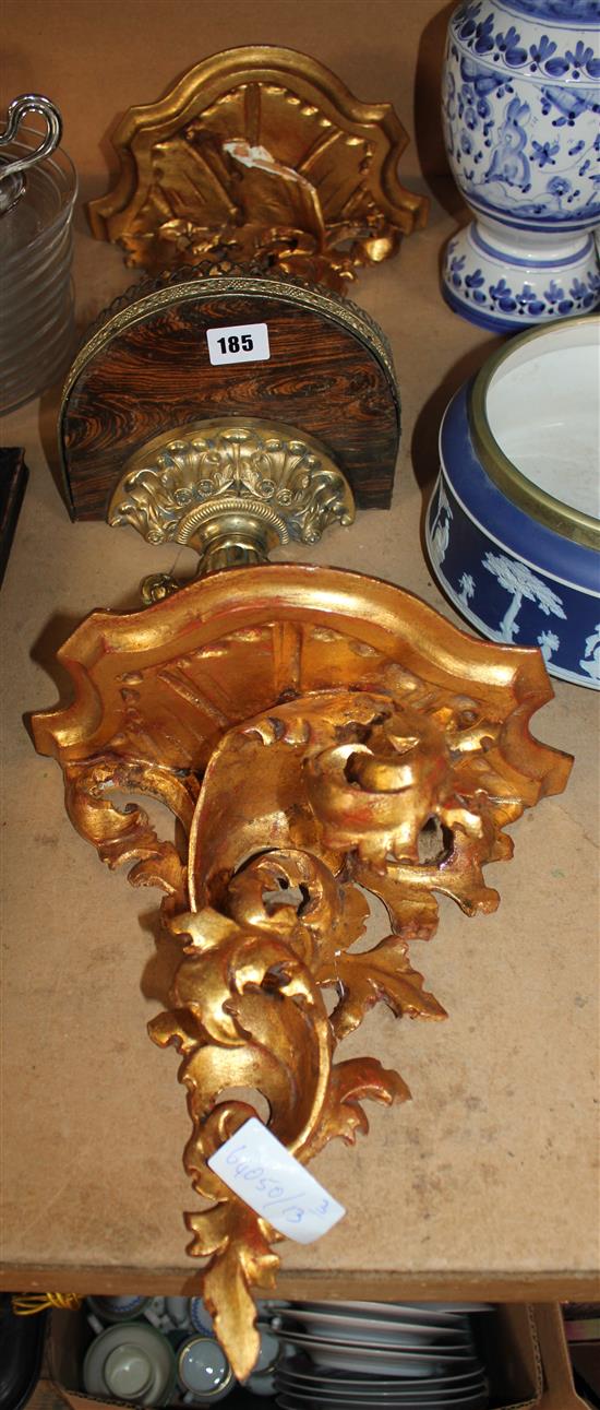Two giltwood wall brackets and a similar gilt metal and faux rosewood bracket(-)